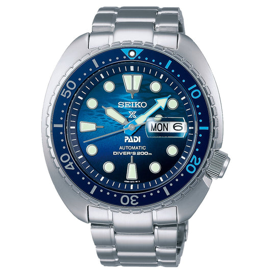 The Seiko Prospex Sea Automatic with Manual Winding 45mm Watch PADI Special Edition is a silver dive watch that showcases an automatic movement and a captivating blue dial with day and date display. Its design features include luminous markers, bold hands, and a rotating bezel with minute markings, offering water resistance up to 200 meters.