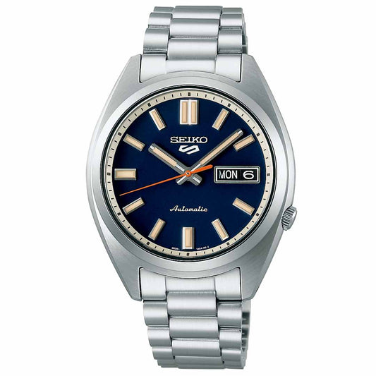 The Seiko 5 Sports SNXS Series Automatic 37.4mm Watch features a stainless steel bracelet and a blue dial. This silver wristwatch showcases an automatic movement, day and date display, silver hour markers, and hands, with the Seiko brand logo elegantly positioned at the top of the dial.