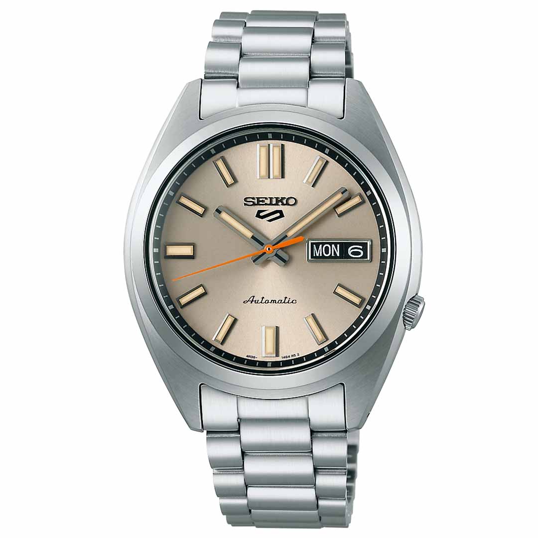 The Seiko 5 Sports SNXS Series Automatic 37.4mm Watch by Seiko features a stainless steel bracelet and case, paired with a beige dial highlighted by black hour markers. Its design includes an easily accessible day and date display on the right side, offering both style and practicality for everyday use.