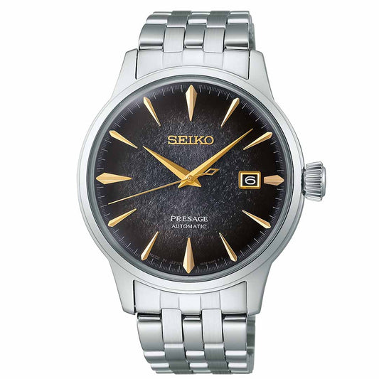 The Seiko Presage Cocktail Time Automatic 40.5mm Watch from Seiko features a sleek silver stainless steel bracelet. The sophisticated black dial is highlighted by gold hour markers and hands, along with a date window at the 3 o'clock position and the iconic Seiko logo at 12 o'clock. A polished metal bezel adds the finishing touch to this elegant timepiece.