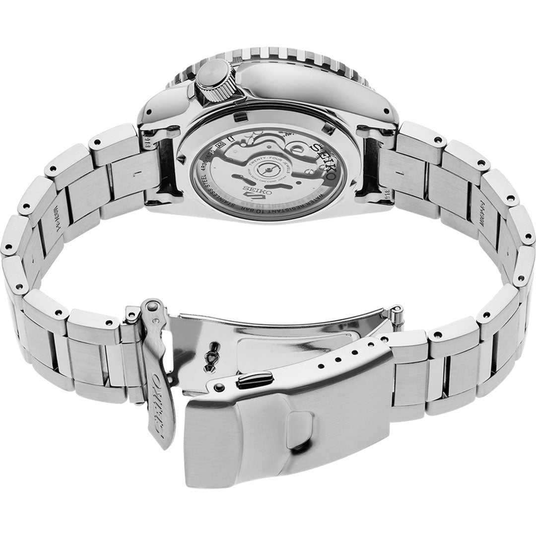 The Seiko 5 Sports SKX Series Automatic 42.5mm Watch by Seiko lies open, showcasing its intricate internal mechanism through a transparent back. This automatic timepiece features a stainless steel linked bracelet with a secure folding clasp, blending elegance with precision.