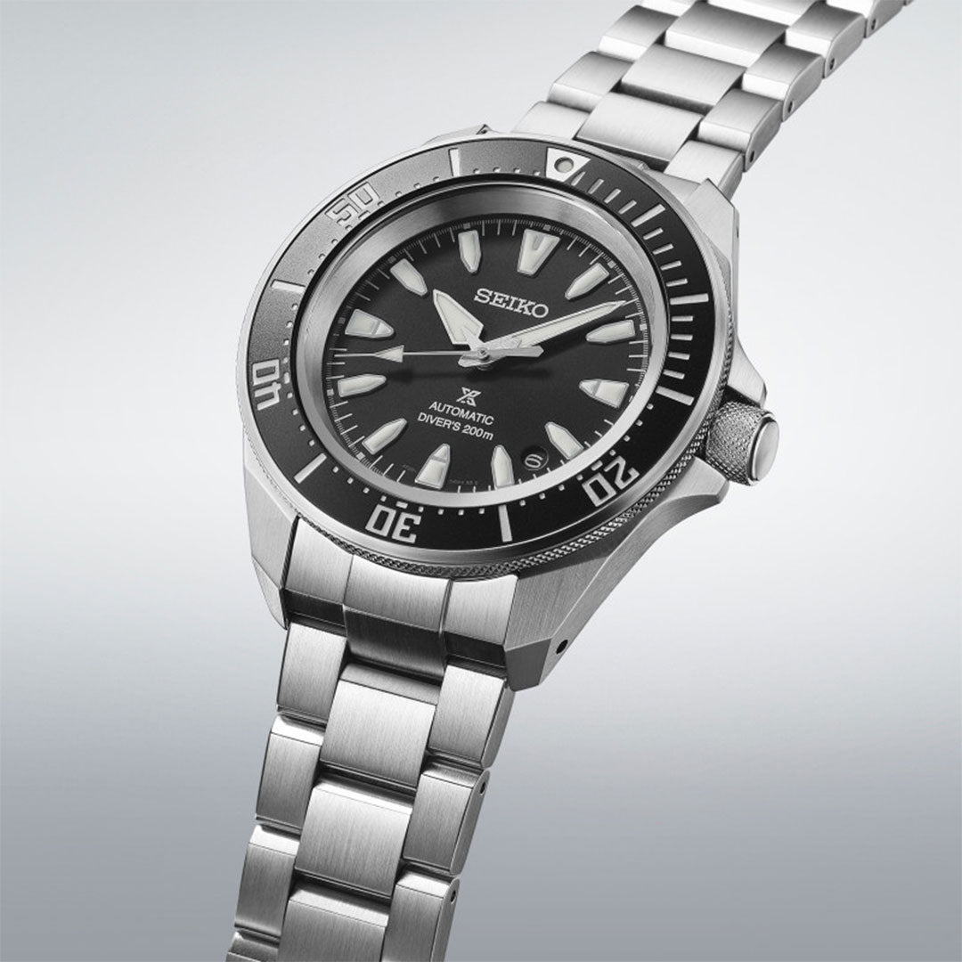 The Seiko Prospex Diver's Automatic 42mm Watch features a sleek stainless steel design with a black dial and silver indices. The Seiko brand logo is displayed on the dial, accompanied by "Automatic Diver's 200m." This diver's watch is equipped with an automatic movement, a metallic strap, and a prominent bezel with minute markers.