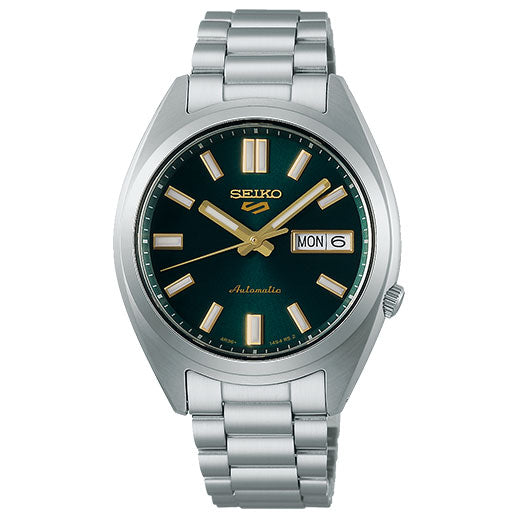 The Seiko 5 Sports SNXS Series Automatic 37.4mm watch features a green dial with gold hour markers and hands, day-date display at 3 o’clock, silver metal bracelet, and “Automatic” above 6 o’clock. Brand: Seiko.