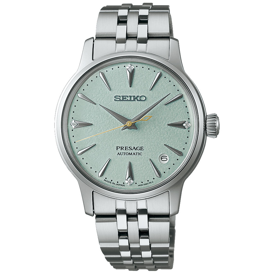 The Seiko Presage Cocktail Time Automatic 34mm watch features a textured light green dial, silver hour markers, a date window at 3 o’clock, and a stainless steel bracelet.