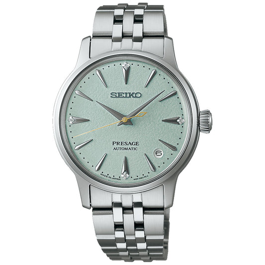 The Seiko Presage Cocktail Time Automatic 34mm watch features a textured light green dial, silver hour markers, a date window at 3 o’clock, and a stainless steel bracelet.