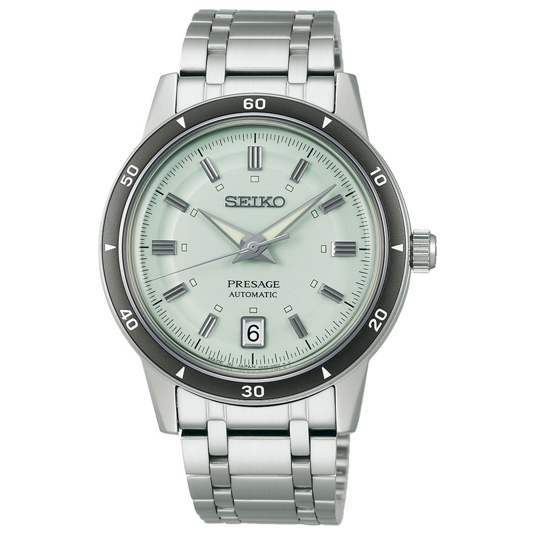 The Seiko Presage Style 60's Automatic with Manual Winding 39.5mm Watch features a silver case, light green dial, date window at 6 o’clock, silver markers and hands, and a stainless steel bracelet.