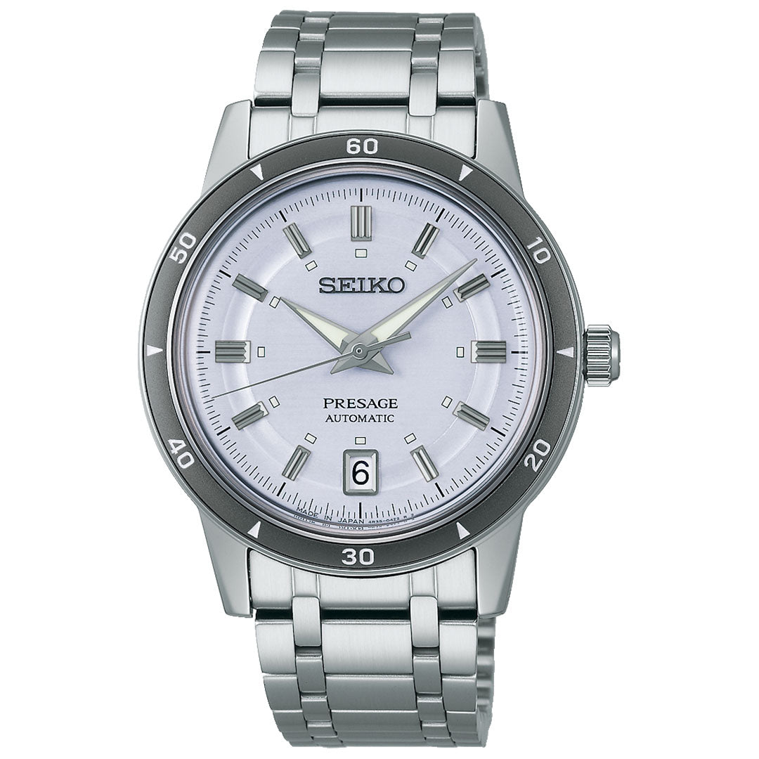 The Seiko Presage Style 60's Automatic with Manual Winding 39.5mm Watch features a round white dial, silver hour markers and hands, a date window at 6 o'clock, and a stainless steel bracelet.