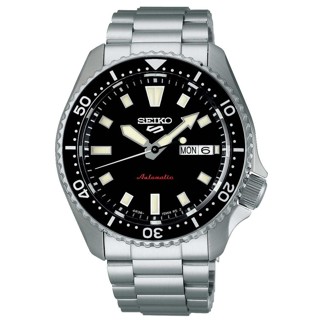 The Seiko 5 Sports SKX Series Automatic 42.5mm watch features a stainless steel case, black sunray dial with white markers and hands, day-date window at 3 o’clock, and a rotating bezel with minute indicators.