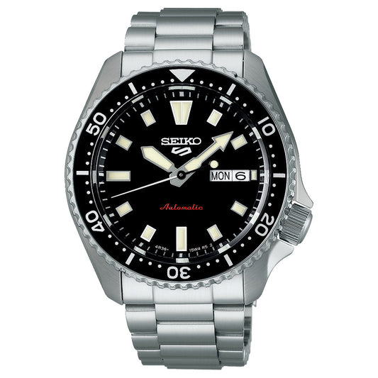 The Seiko 5 Sports SKX Series Automatic 42.5mm watch features a stainless steel case, black sunray dial with white markers and hands, day-date window at 3 o’clock, and a rotating bezel with minute indicators.