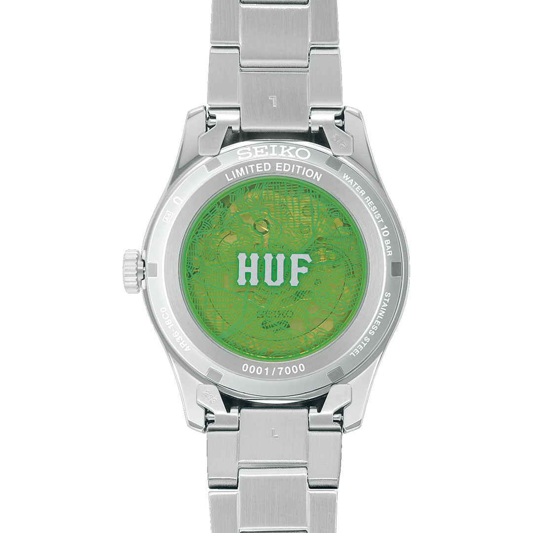 The Seiko 5 Field Series Automatic 39.4mm Watch HUF Limited Edition of 7,000 features a green transparent case back with circuitry patterns, bold “HUF” lettering, “Limited Edition,” and is individually numbered.