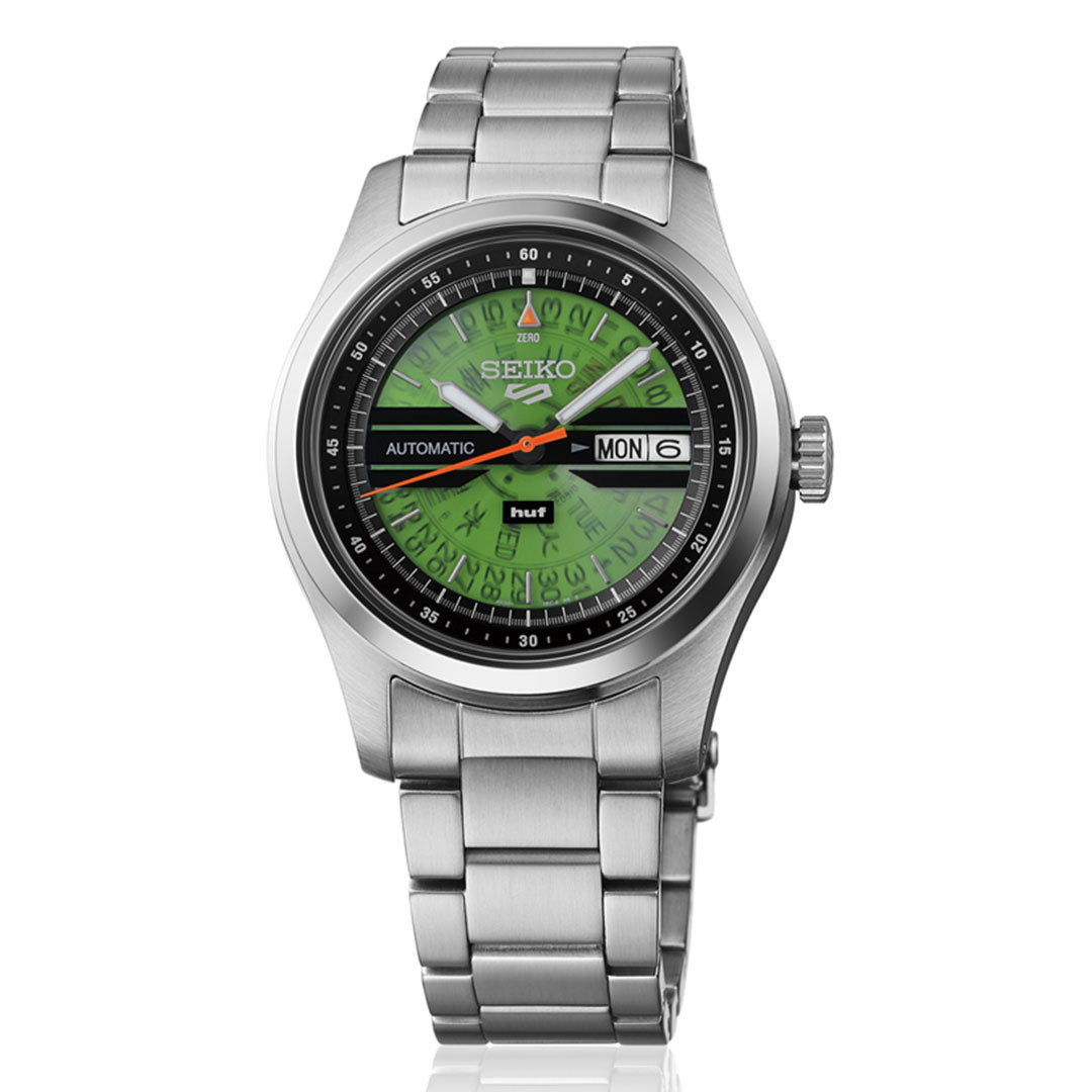 The Seiko 5 Field Series Automatic 39.4mm Watch HUF Limited Edition (7,000 pieces) features a green dial, black outer ring, silver hands, and day-date display at 3 o’clock.