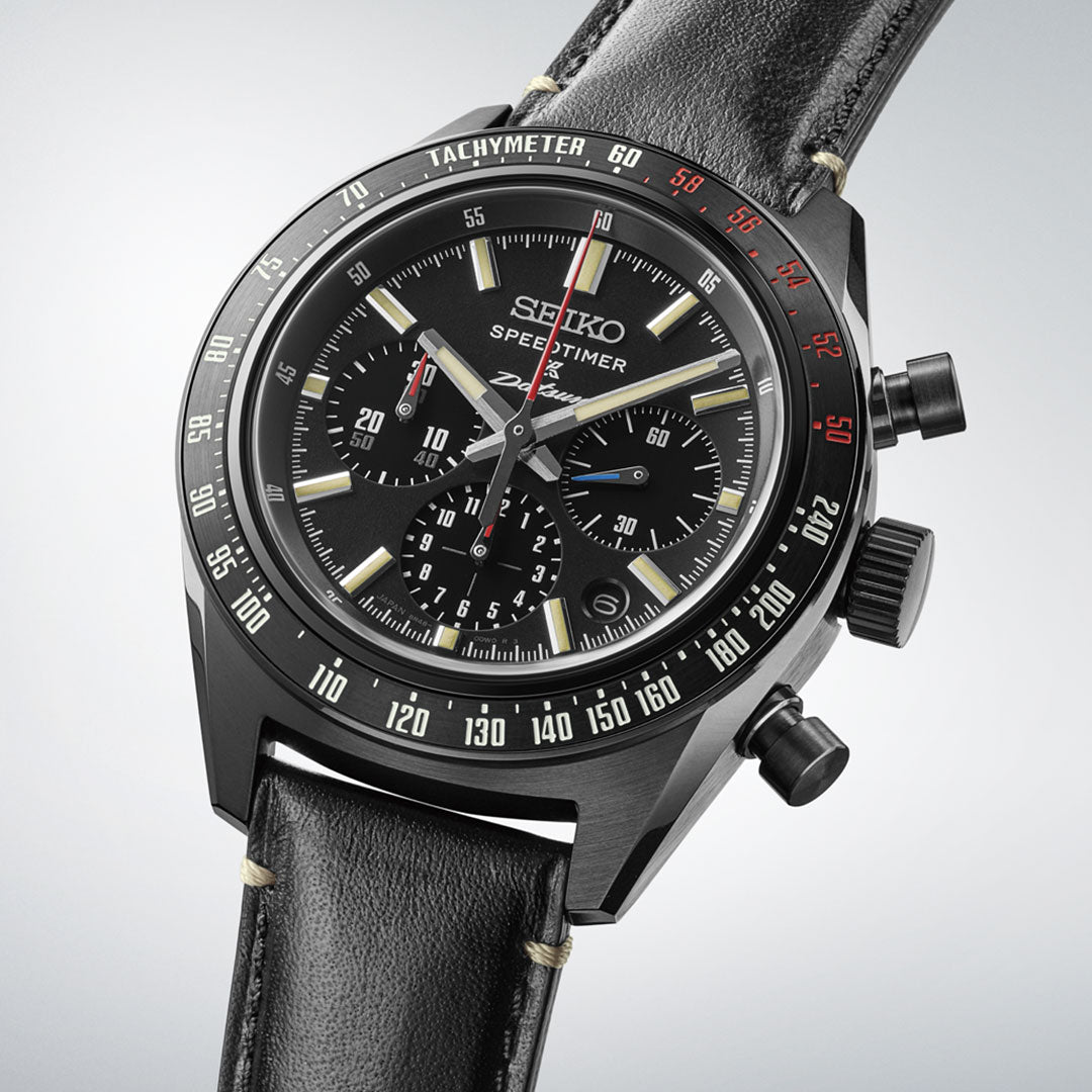 The Seiko Prospex Speedtimer Datsun 240Z Chronograph Automatic, a 42mm limited edition of 500 pieces, features a black dial with three subdials, tachymeter bezel, and black leather strap, shown angled on a light background.