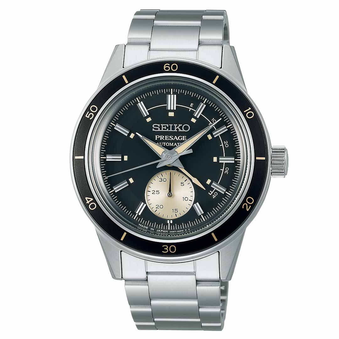 The Seiko Presage Style 60's Automatic 40.8mm Watch features a stainless steel bracelet and is distinguished by its black bezel and dial. Its elegant design is accented with silver and gold-tone hands and hour markers, alongside a small sub-dial at the 6 o'clock position, making it a timeless accessory for any occasion.