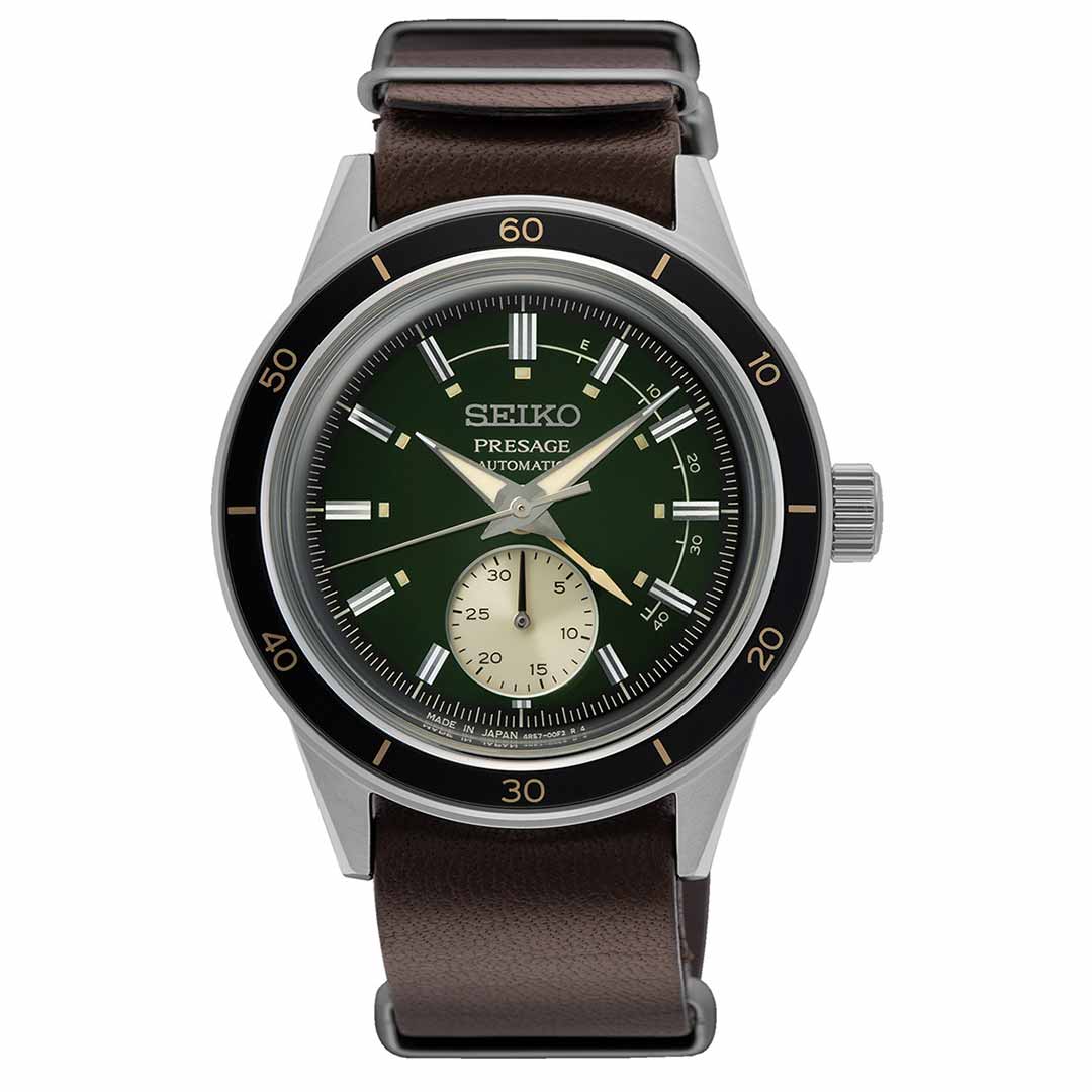 The Seiko Presage Style 60's Automatic 40.8mm Watch by Seiko features a captivating green dial with a small seconds subdial, silver hour markers, and a sophisticated black bezel. It comes with a sleek silver casing and is paired with an elegant brown leather strap.