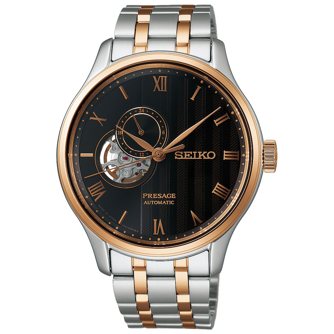 The Seiko Presage Japanese Garden Automatic 41.8mm watch features a black dial with gold Roman numerals, an open-heart display, and a two-tone silver and gold metal bracelet.