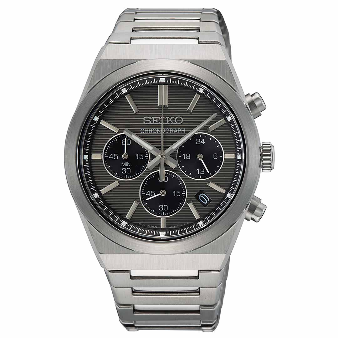 The Seiko Essentials Quartz 40mm Watch showcases a gray dial with three subdials and a date window. Its elegant hands and detailed bracelet are made from stainless steel, complementing the metallic bezel and casing that highlight its design. Water-resistant, this timepiece is ideal for everyday wear.