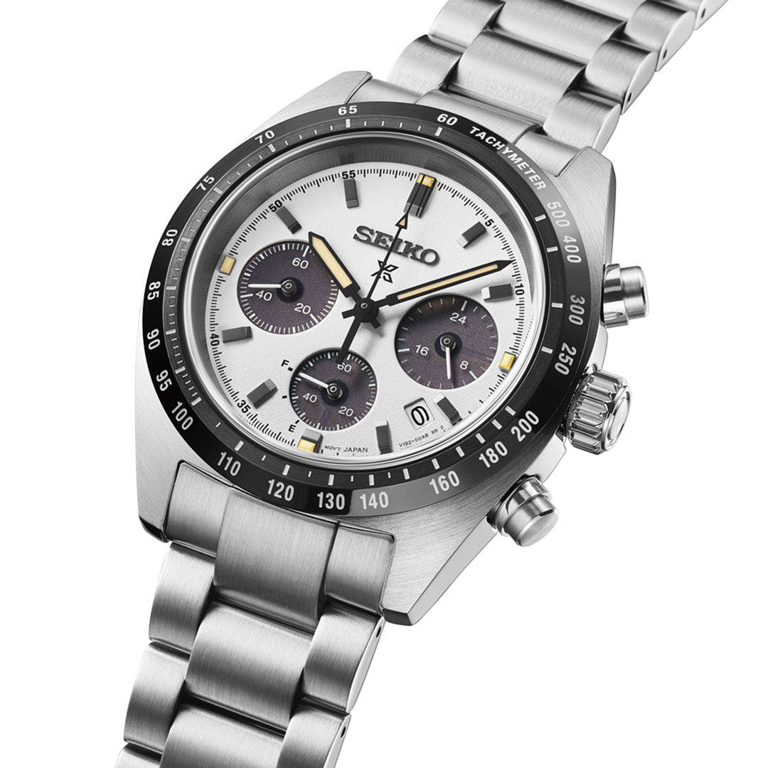 The Seiko Prospex Speedtimer Solar Chronograph 39mm Watch features a silver metal band, white dial, black bezel, three black subdials, sandblast finish, curved sapphire glass, tachymeter scale, and date window.