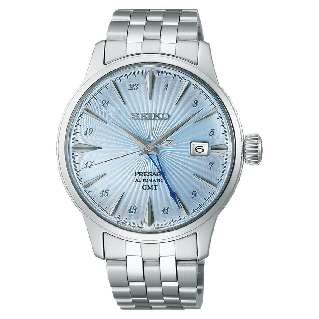 The Seiko Presage Cocktail Time Automatic with Manual Winding 40.5mm Watch exudes elegance with its stainless steel bracelet and captivating sunburst-patterned light blue dial. Its refined appearance is enhanced by silver-tone hands, hour markers, and a date window positioned at 3 o'clock.