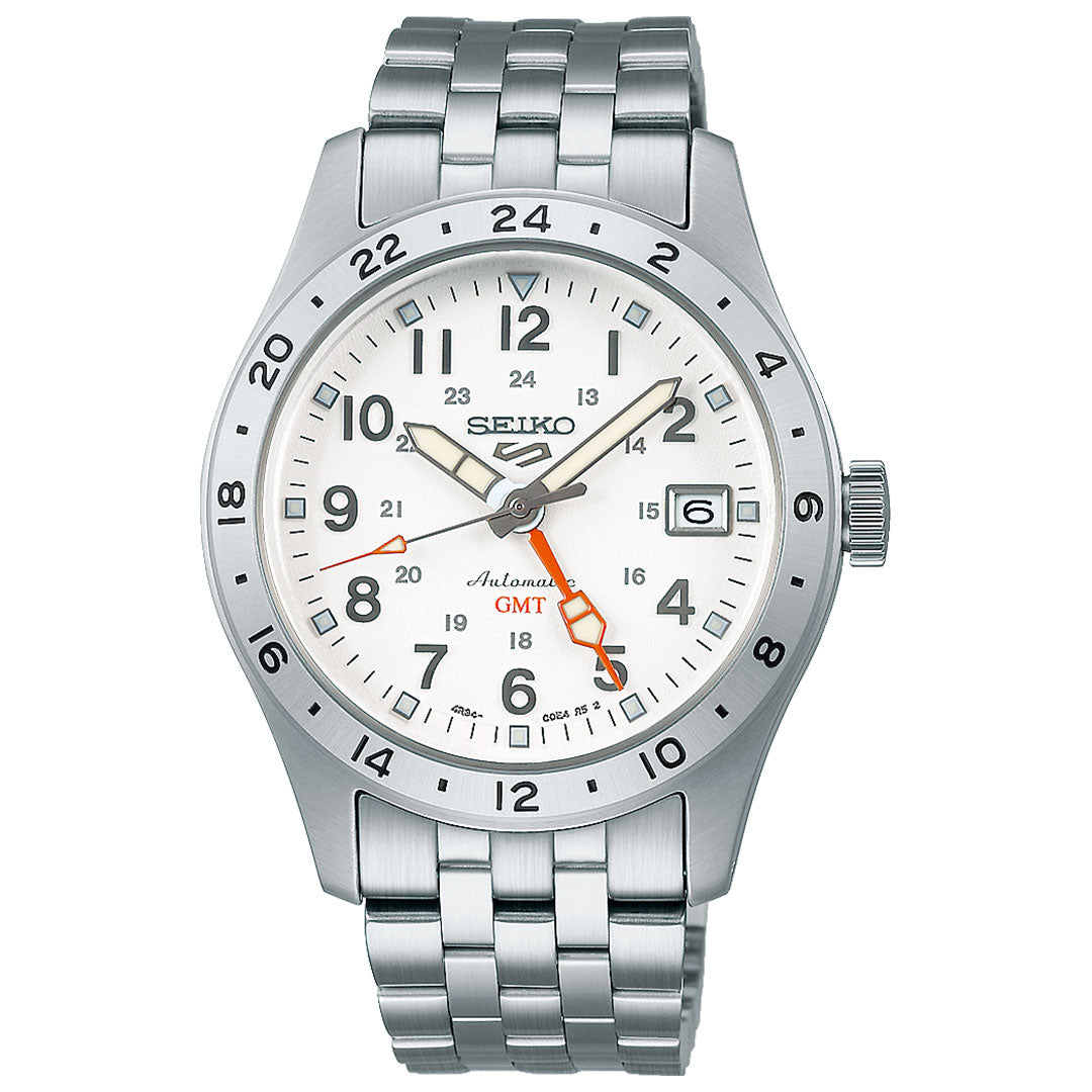 The Seiko 5 Sports Field Series Automatic 39.4mm watch features a white dial, silver-tone stainless steel case and bracelet, black hour markers, date window at 3 o’clock, and a red GMT hand pointing to 22 on the bezel.