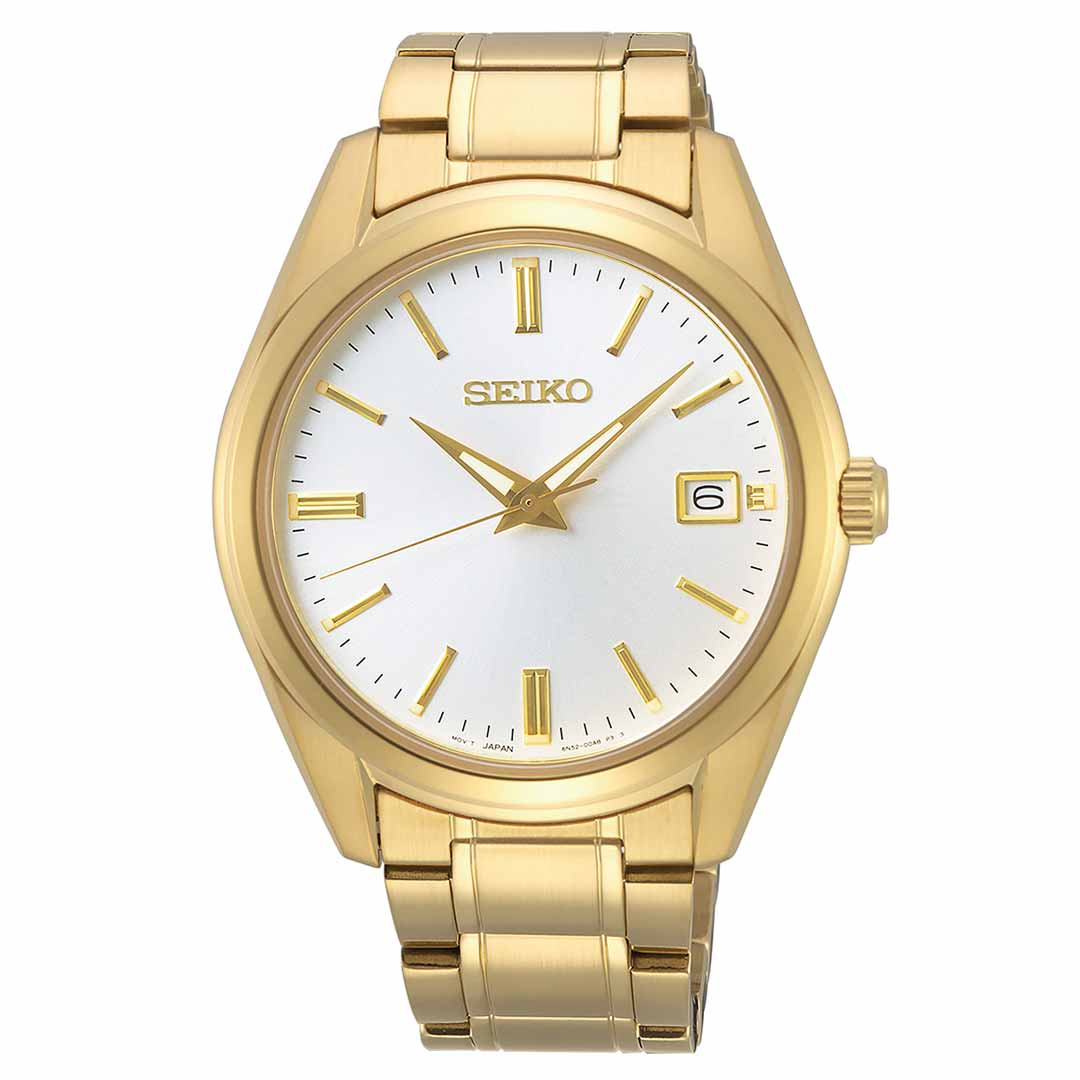 The Seiko Essentials Quartz 40.2mm Watch boasts a gold-plated finish with a white dial, featuring gold hour markers and a date display at the 3 o'clock position. The "Seiko" brand name is elegantly positioned beneath the 12 o'clock mark, and it is powered by the dependable Calibre 6N52 quartz movement within its gold metal bracelet.