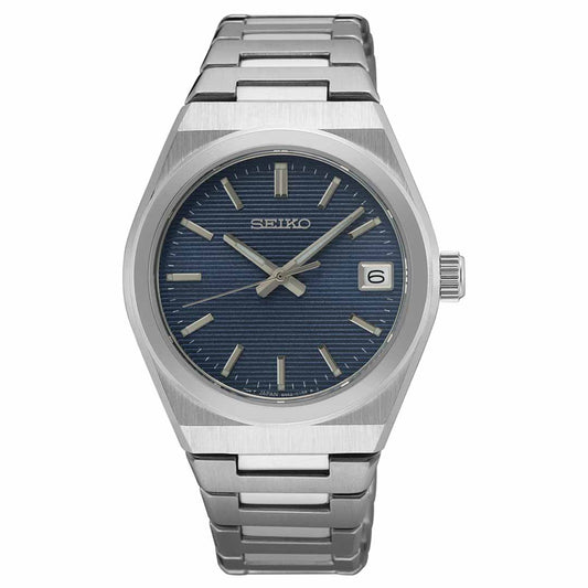 The Seiko Essentials Quartz 34mm Watch by Seiko showcases timeless elegance with its sleek silver design. It features a blue textured dial, complemented by silver hour markers, and includes a date display at the 3 o'clock position. The stainless steel band adds sophistication, making it an ideal choice for any occasion.