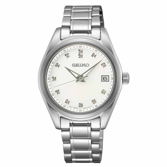 The Seiko Diamonds Quartz 32mm Watch is a silver timepiece featuring a white face, metallic hour markers, and a date display at the 3 o'clock position, protected by a sapphire crystal. It boasts a linked metal band and embodies a classic, elegant design.