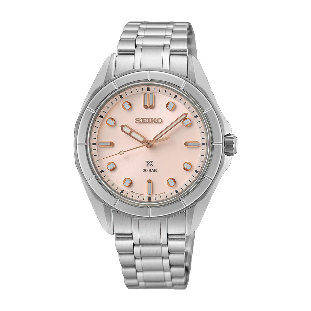 The Seiko Prospex Sea Quartz 34mm Watch features a silver metal band and a round, light pink dial with silver hour markers, three hands, and the Seiko logo at the top. Its minimalistic design offers an elegant look characteristic of Seiko’s craftsmanship.