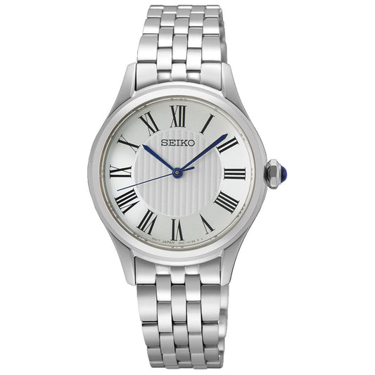 The Seiko Classic Quartz 29.6mm Watch features a silver metal link band, white face with black Roman numerals, blue hands, and a blue cabochon crown—a simple, elegant design by Seiko.