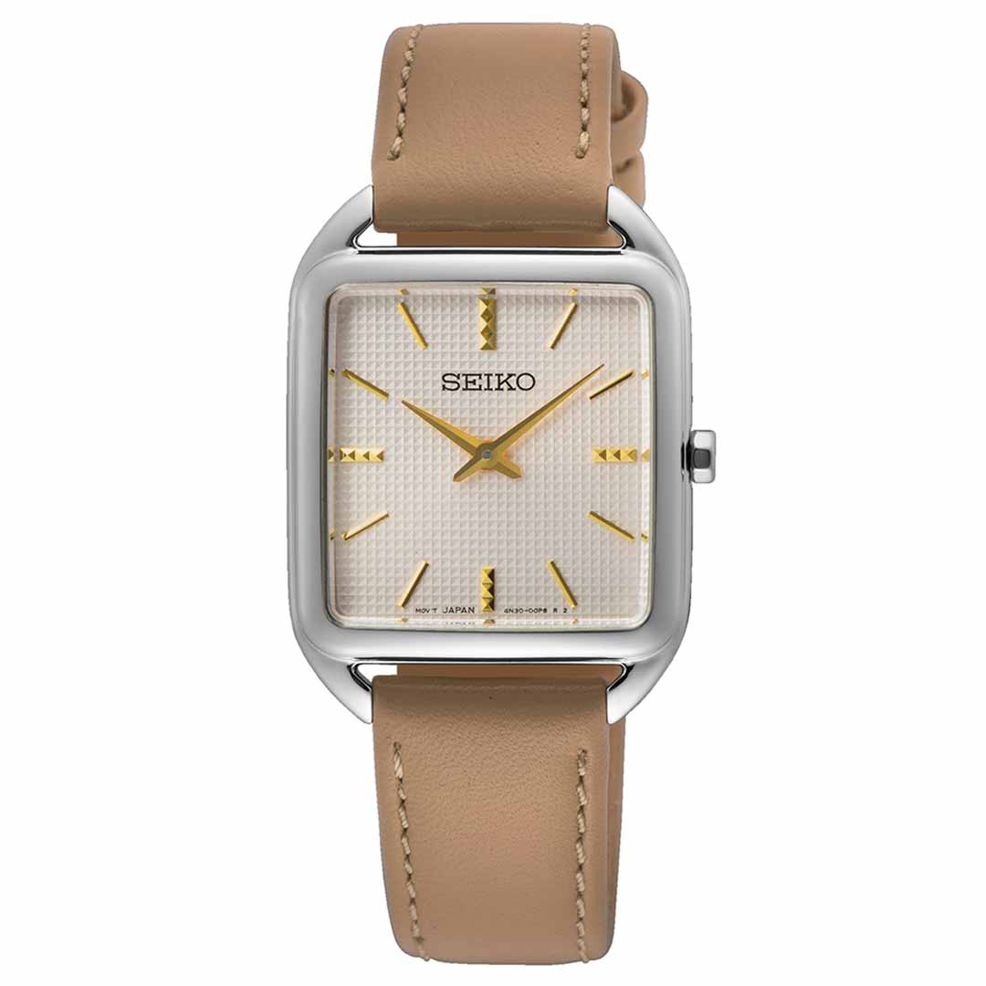 The Seiko Essentials Quartz 26mm Watch, by Seiko, features a chic rectangular design with a cream-colored face complemented by gold hour markers. Its sleek silver frame harmonizes beautifully with the light brown leather strap, while the gold hands and Hardlex Crystal enhance its minimalist durability.