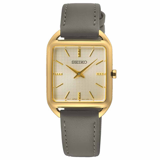 The Seiko Essentials Quartz 26mm Watch boasts a gold-plated square case and a textured beige dial. Hardlex Crystal safeguards the gold hour markers and hands, pairing stylishly with a gray leather strap, while the distinguished Seiko logo adorns its refined face.