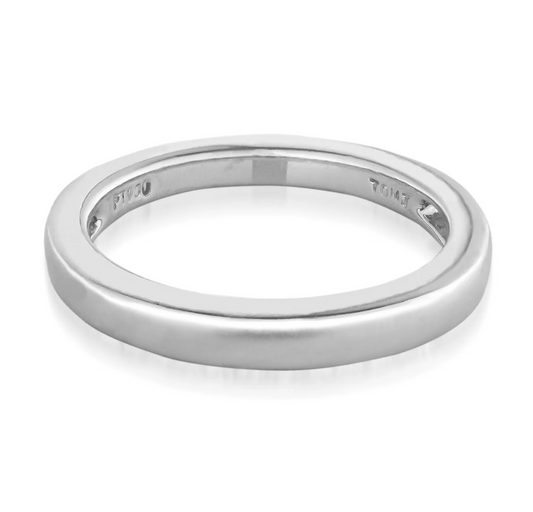 A sleek and sophisticated 14K white gold wedding band in size 5.5, featuring a smooth, polished finish. The interior of the ring is engraved with markings, including "PT 950." It is showcased against a plain white backdrop. This elegant piece is crafted by Raffi Jewellers - Canada.