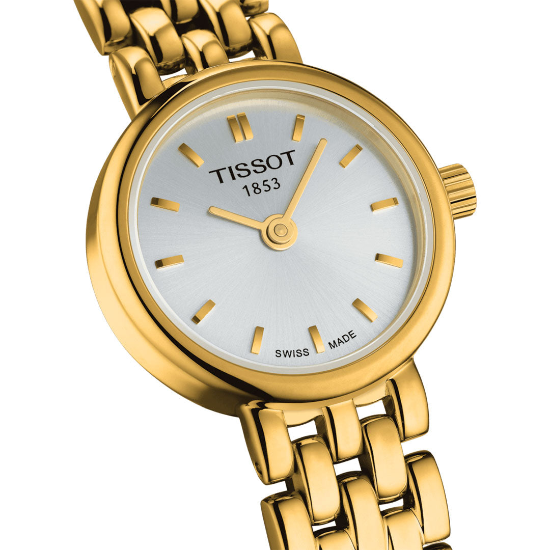 A mini-size Tissot Lovely Quartz 19.5mm watch with a metallic silver face, slender gold hour markers, and dual gold hands. The dial showcases "Tissot 1853" and "Swiss Made," complemented by a luxurious gold link bracelet that epitomizes elegance in timepieces.