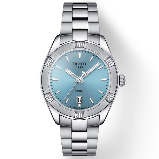 The Tissot PR 100 Lady Sport Chic Quartz 36mm Watch is a stainless steel timepiece featuring a blue dial with silver hour markers and hands. It is equipped with Swiss Quartz Movement and has a date display at the 6 o'clock position. The polished metal bracelet pairs beautifully with its numerically marked bezel, offering a classic appeal.