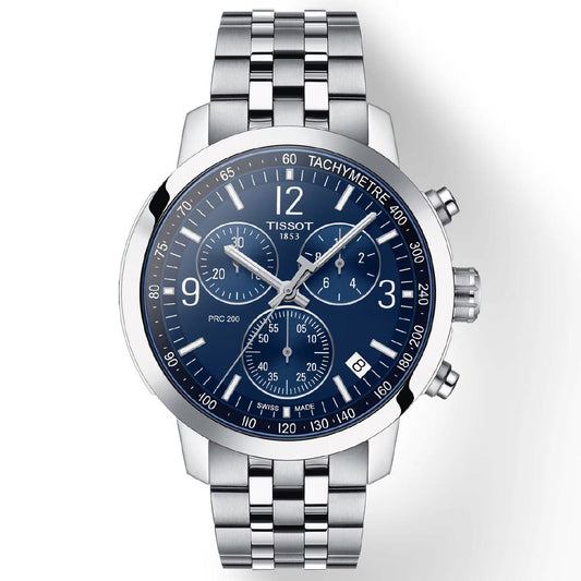 The Tissot PRC 200 Chronograph Quartz 42mm watch is a silver stainless steel wristwatch featuring a blue dial with three subdials, silver hour markers, and a tachymeter scale on the bezel. The chronograph buttons are positioned on the right side, and the date display is situated at 4 o'clock. This timepiece boasts Swiss Quartz Movement for precision.