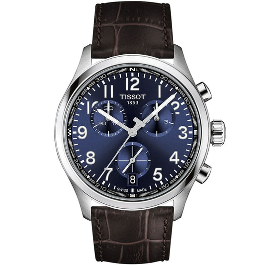 The Tissot CHRONO L Quartz 42mm watch by Tissot features a blue dial with white numerals, silver-tone case, Swiss quartz movement, three subdials, and a brown leather strap with crocodile pattern. The time displayed is 1:53:13.