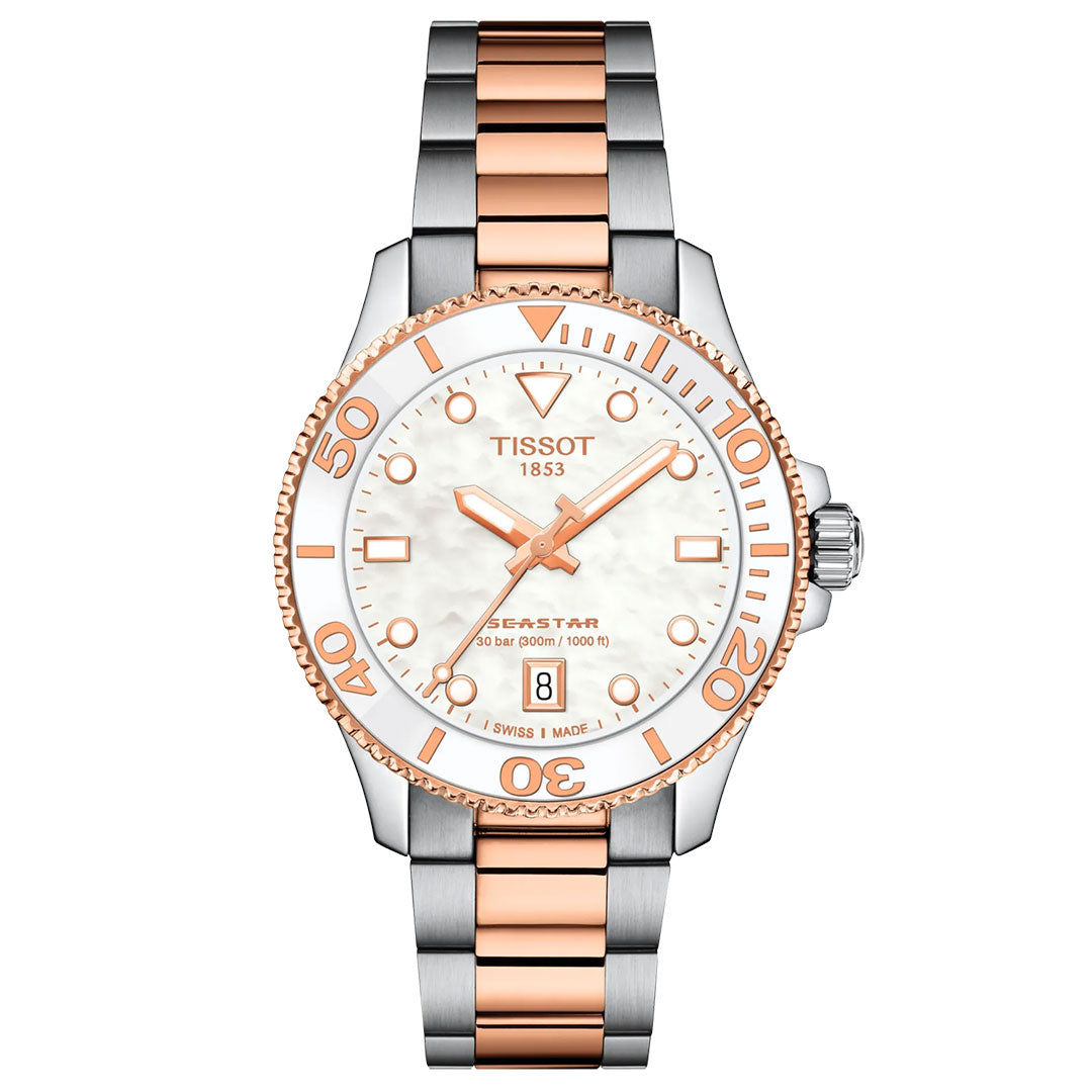 The Tissot Seastar 1000 Quartz 36mm Watch features a stainless steel and rose gold band, white mother-of-pearl dial, rose gold bezel, sapphire crystal, date at 6, Swiss Quartz movement, and is water-resistant to 300 meters.