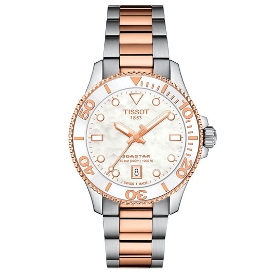 The Tissot Seastar 1000 Quartz 36mm Watch features a stainless steel and rose gold band, white mother-of-pearl dial, rose gold bezel, sapphire crystal, date at 6, Swiss Quartz movement, and is water-resistant to 300 meters.
