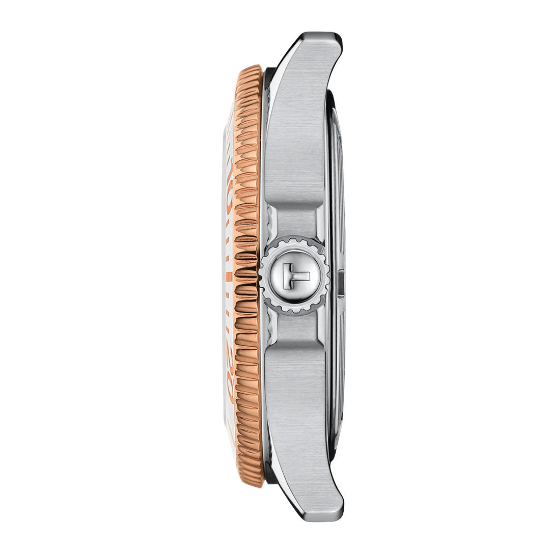 Side view of the Tissot Seastar 1000 Quartz 36mm Watch shows a stainless steel case, rose gold ridged bezel, and crown with the Tissot "T" logo. A scratch-resistant sapphire crystal protects the face.