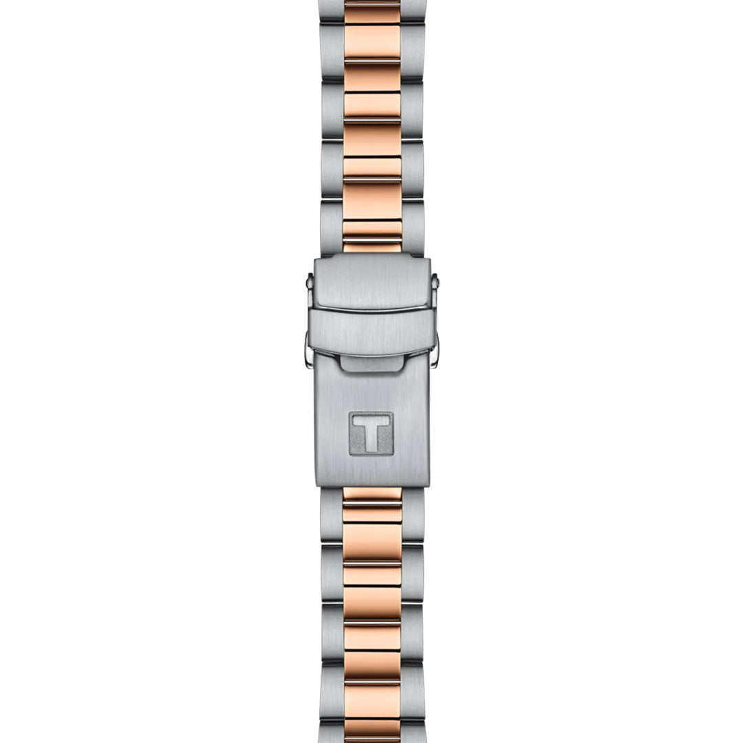 The Tissot Seastar 1000 Quartz 36mm Watch features a stainless steel strap with silver and rose gold links, a clasp engraved with the "T" logo, and Swiss Quartz movement for lasting style and precision.