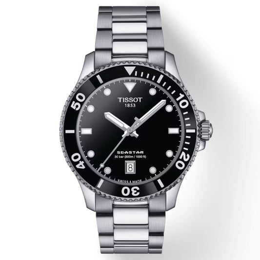 The Tissot Seastar 1000 Quartz 40mm Watch is a stainless steel dive timepiece featuring a black dial and bezel, complemented by white hour markers and hands. Embodying Swiss watchmaking excellence, this watch displays the date at the 6 o'clock position and proudly bears the "Tissot 1853" and "Seastar" engravings on its face for superior water resistance.