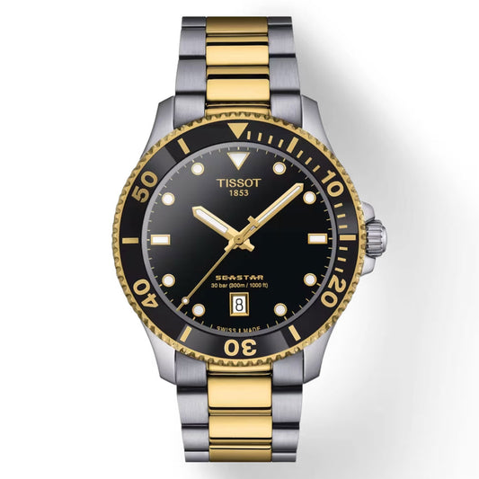 The Tissot Seastar 1000 Quartz 40mm Watch features a black dial adorned with gold-tone hour markers and hands, highlighted with Super-LumiNova for enhanced visibility. Its two-tone gold and silver stainless steel bracelet perfectly matches the bezel, which is detailed with engraved numbers and dots. A date window is prominently located at the 6 o'clock position.