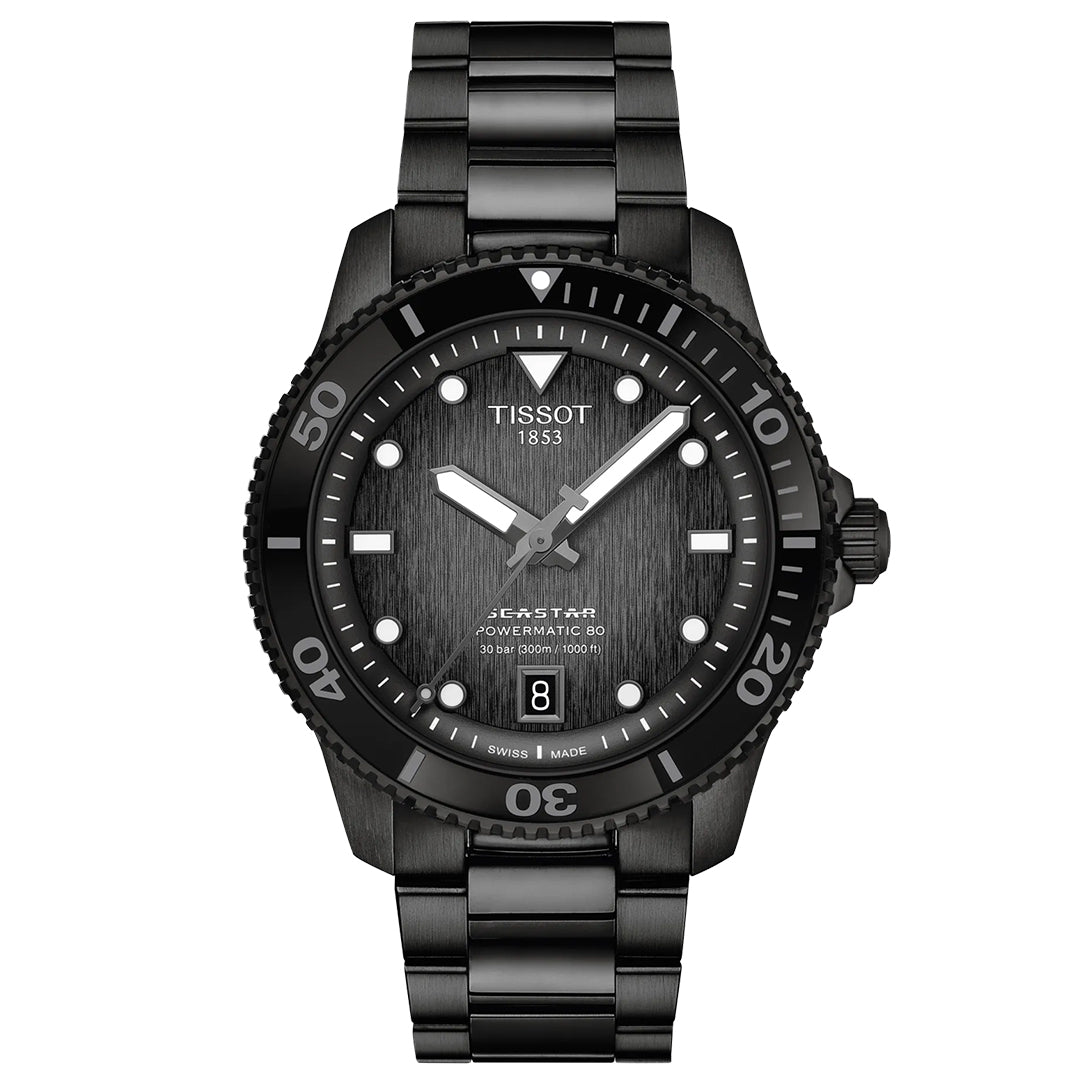 The Tissot Seastar 1000 Powermatic 80 Automatic 40mm Watch features a black dial, white markers, scratch-resistant sapphire crystal, date window at 6 o’clock, and black metal bracelet, shown against a white background.