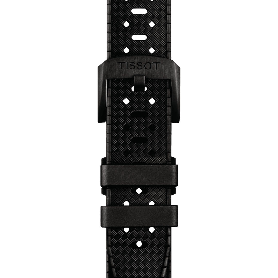 Close-up of a black strap from the Tissot Seastar 1000 Powermatic 80 Automatic 40mm Watch, showcasing its textured pattern and silver buckle. The Super-LumiNova details are highlighted, with small holes for adjustment and two loops to secure the end.