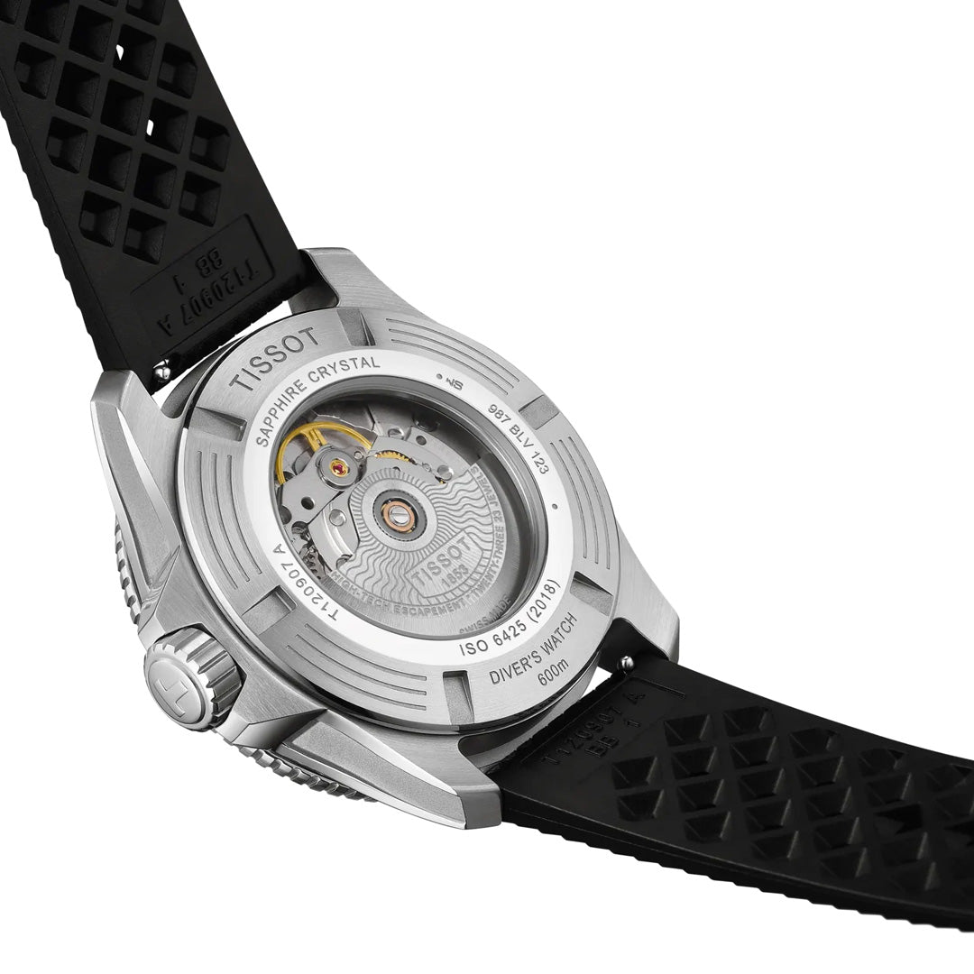 Close-up of the back of the Tissot Seastar 2000 Powermatic 80 Automatic 44mm Watch, revealing its sophisticated automatic movement through a transparent caseback. The textured black rubber strap and engraved details encircling the edge showcase the refined craftsmanship and quality synonymous with Tissot.