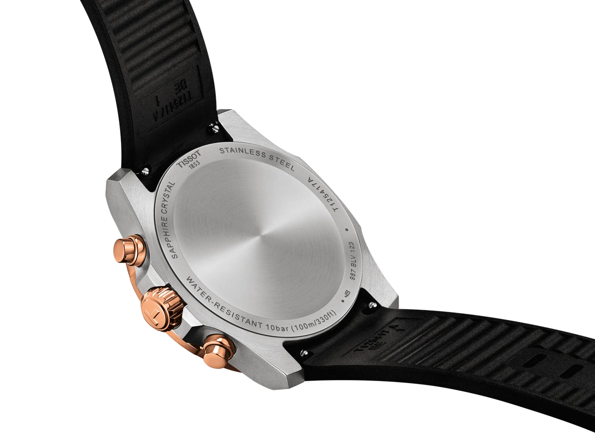 The case back of a Tissot Supersport Chrono Quartz 42mm Watch, shown with a black rubber strap and copper-toned pushers.