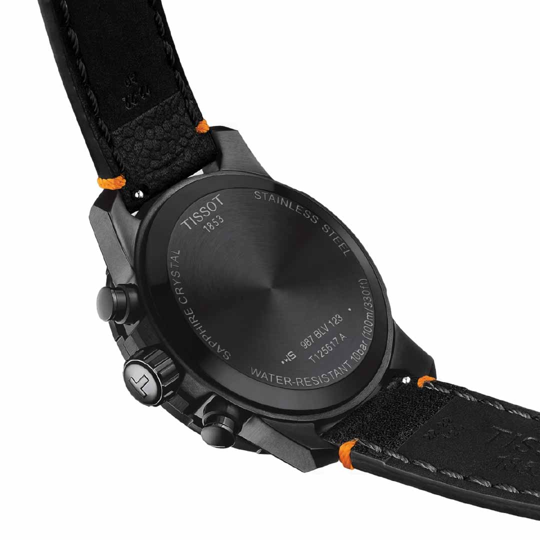 The image displays the back of the Tissot Supersport Chrono Basketball Edition Quartz 45.5mm Watch, highlighting a black leather strap with orange stitching. This Swiss-made watch exemplifies craftsmanship with features such as water resistance and stainless steel construction, underscoring its basketball edition heritage.