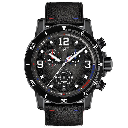The Tissot Supersport NBA Special Edition Quartz 45.5mm Watch features a black textured dial with three subdials, white numerals, red, blue, and white accents on bezel and strap, black leather band, and standout crown and pushers.