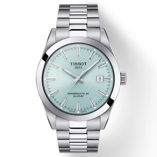 The Tissot Gentleman Powermatic 80 Silicium Automatic 40mm Watch boasts a mint green face adorned with silver hour markers and a date window at 3 o'clock. Its 316L stainless steel case is paired with a metal link bracelet, while the inscription "Powermatic 80 Silicium" highlights its dependable automatic movement, perfect for any occasion.