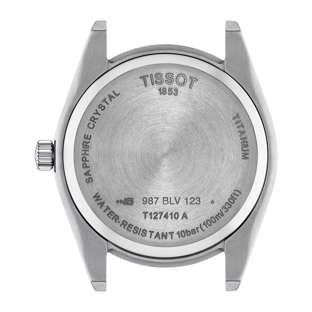 The Tissot Gentleman Titanium Quartz 40mm Watch has a titanium caseback engraved with "Sapphire Crystal," "Tissot 1853," "Titanium," "Water-Resistant 10 bar (100 m / 330 ft)," model T127410 A, and features a Swiss Quartz movement.
