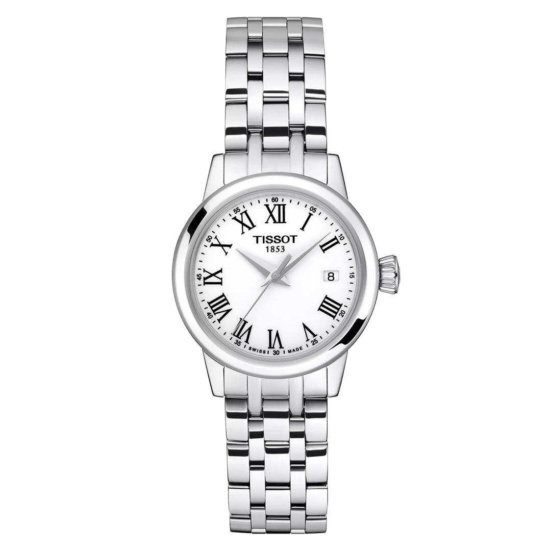 The Tissot Classic Dream Lady Quartz 28mm Watch with a silver metal bracelet exudes sophistication. This elegant timepiece is equipped with a white dial featuring Roman numerals, slender black hands, and a date display. The Tissot logo and "1853" are gracefully printed below the 12 o'clock position.